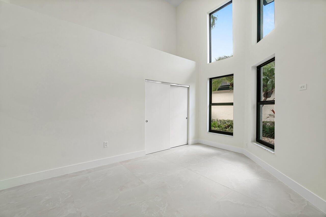 5529 Steeple Chase Boca Raton, FL 33496 - Photo 27 of 56 an empty room with windows