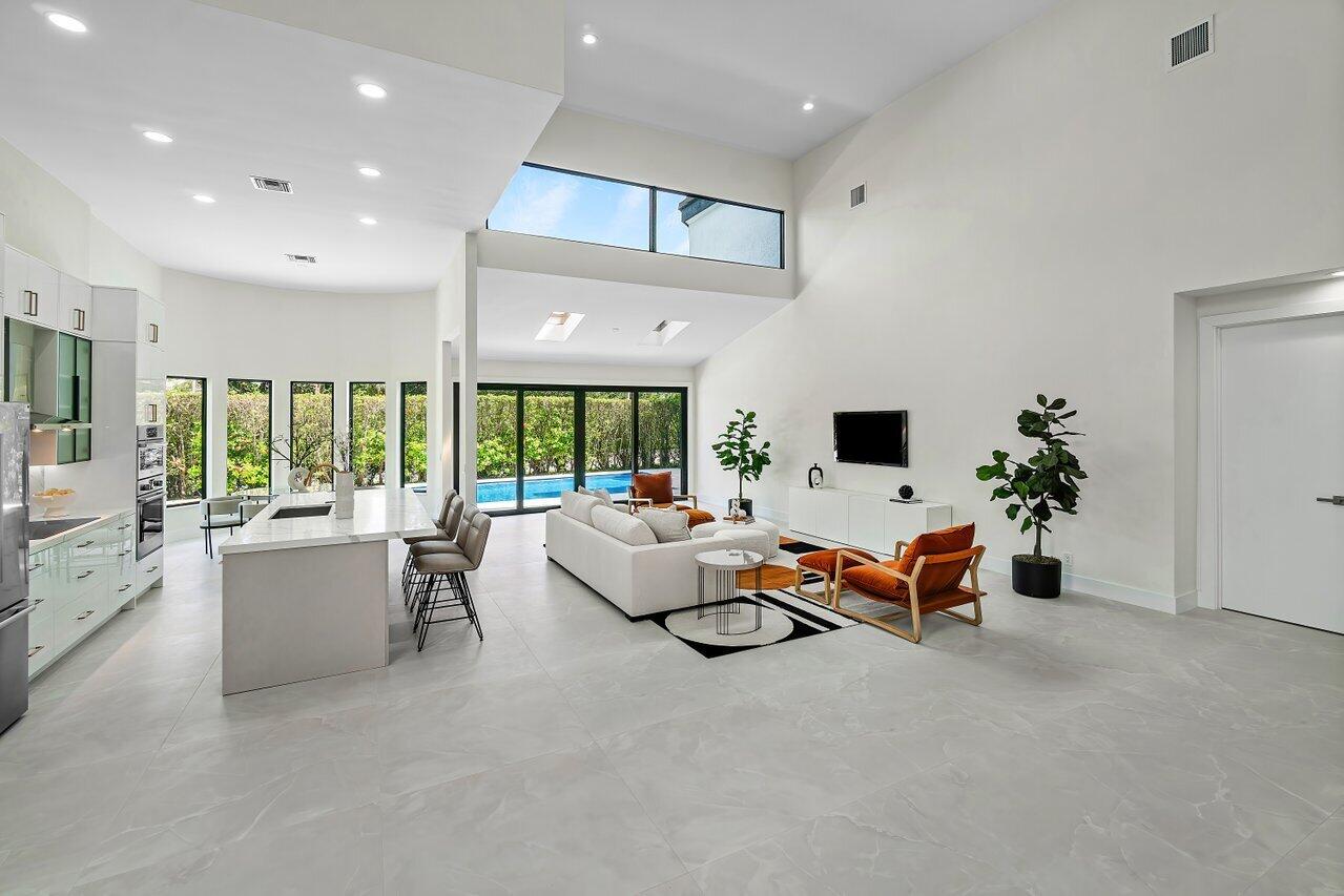 5529 Steeple Chase Boca Raton, FL 33496 - Photo 5 of 56 a living room with furniture fireplace and garden view