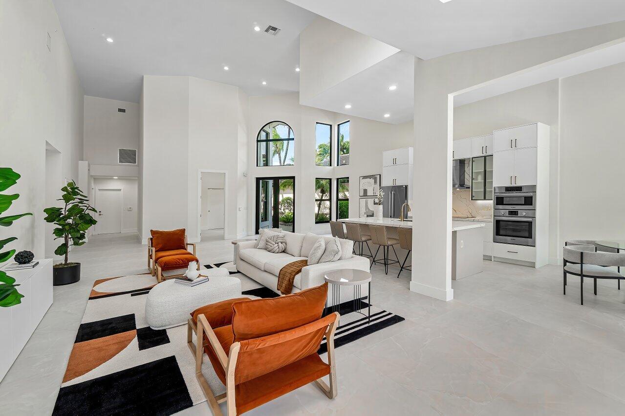 5529 Steeple Chase Boca Raton, FL 33496 - Photo 6 of 56 a living room with furniture a rug and white walls