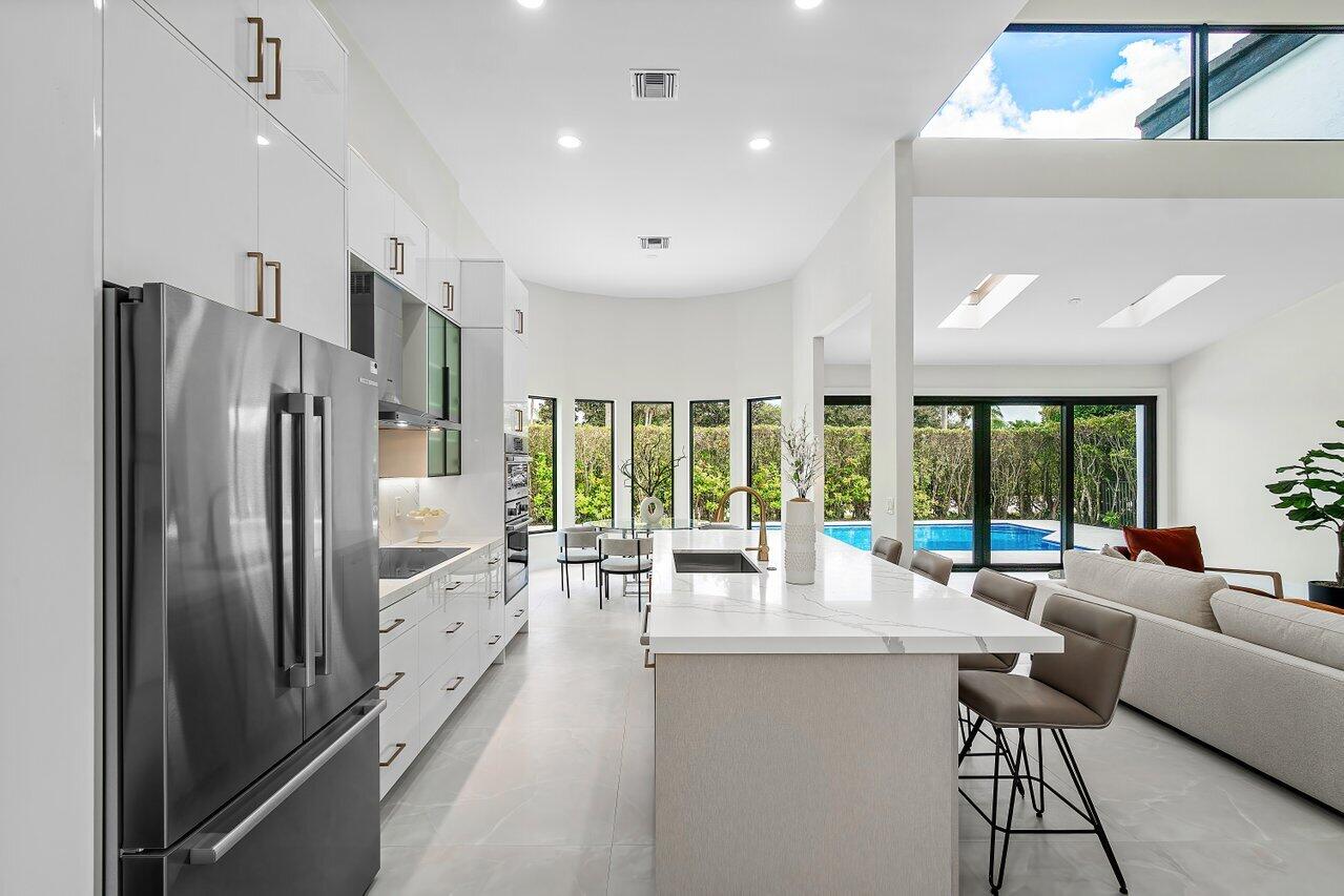 5529 Steeple Chase Boca Raton, FL 33496 - Photo 9 of 56 a kitchen with stainless steel appliances granite countertop a refrigerator and a couch