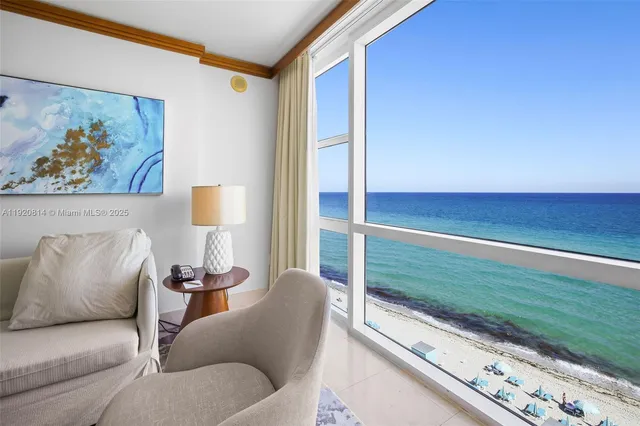 a living room with furniture and a floor to ceiling window