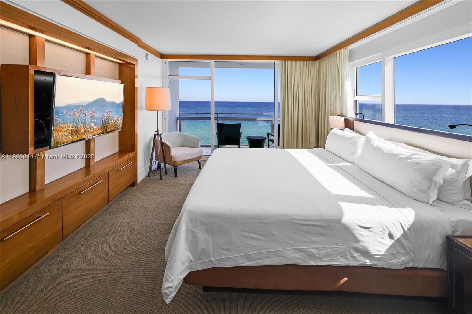 6801 Collins Avenue, Unit 822(DOOR) Miami Beach, FL 33141 - Photo 8 of 30 a bedroom with a large bed and a balcony view