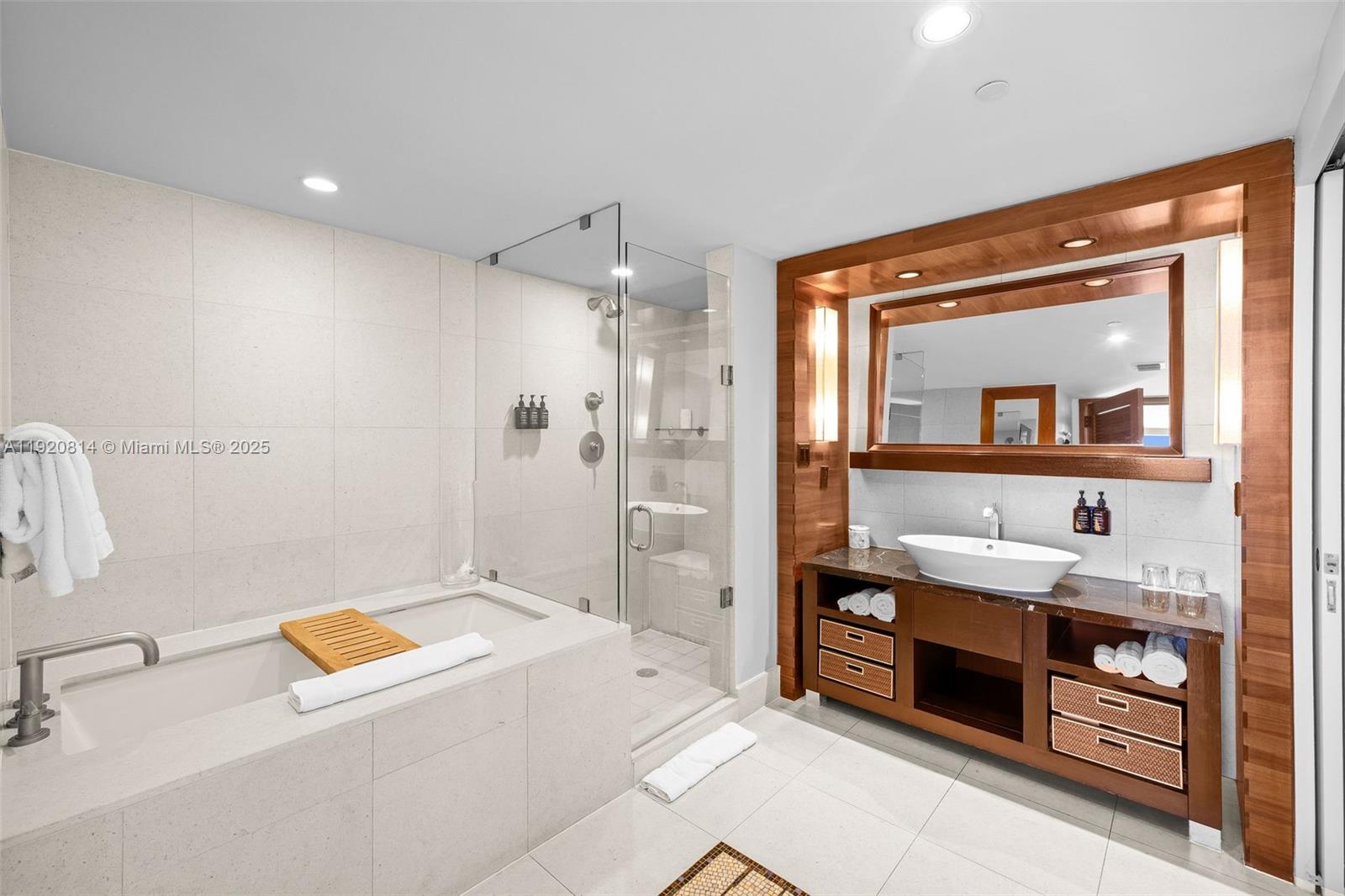 6801 Collins Avenue, Unit 822(DOOR) Miami Beach, FL 33141 - Photo 9 of 30 a spacious bathroom with a tub sink and mirror