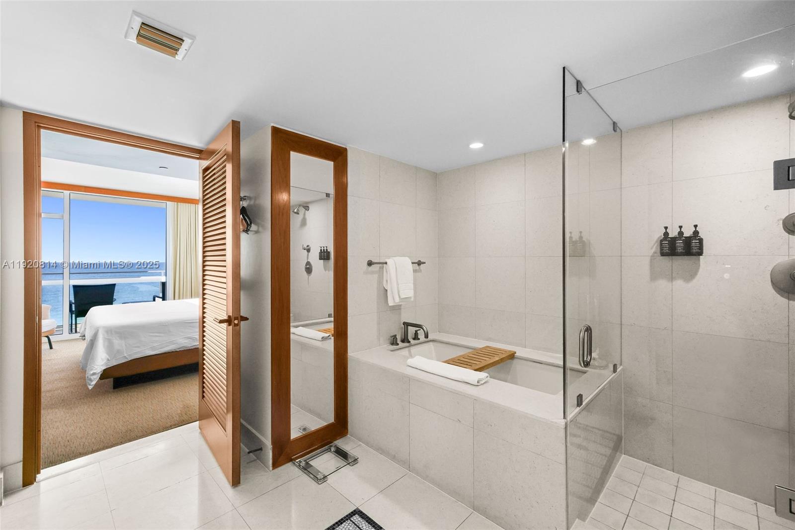 6801 Collins Avenue, Unit 822(DOOR) Miami Beach, FL 33141 - Photo 10 of 30 a bathroom with a tub shower and bedroom view