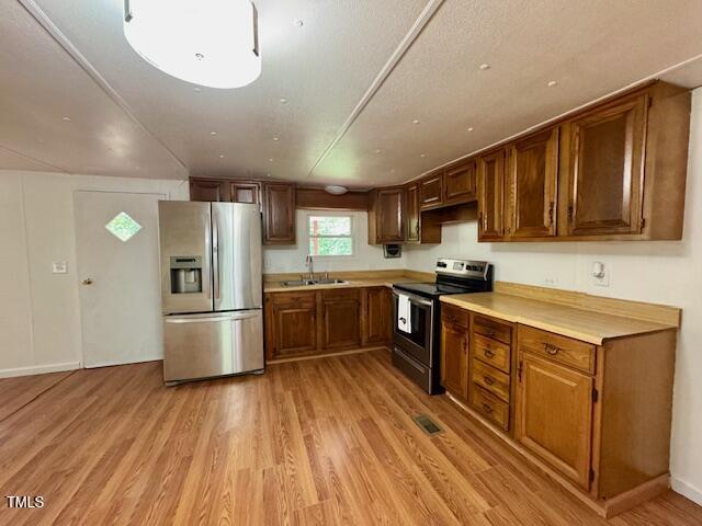 951 Harris Mill Road Rougemont, NC 27572 - Photo 20 of 89 a kitchen with stainless steel appliances a refrigerator a sink dishwasher a stove with wooden floors