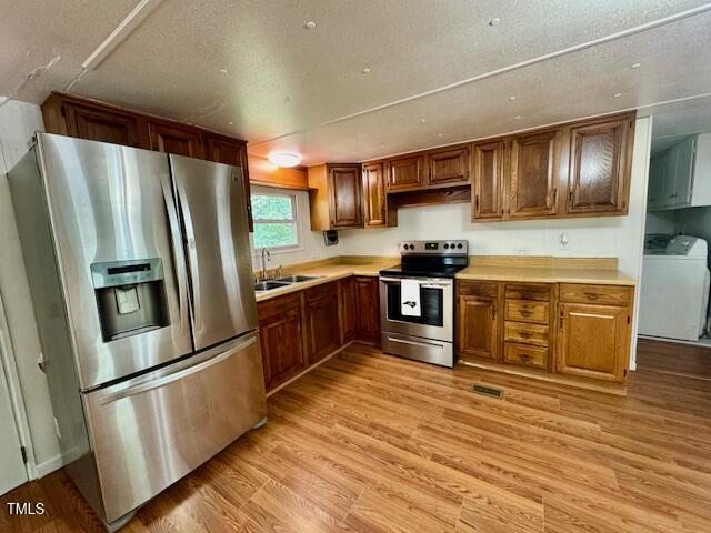 951 Harris Mill Road Rougemont, NC 27572 - Photo 32 of 89 a kitchen with stainless steel appliances granite countertop a stove top oven a refrigerator and white cabinets with wooden floors