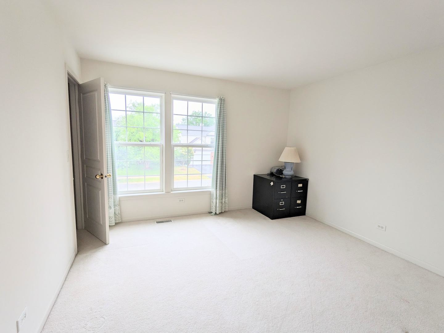 24632 Apollo Drive Plainfield, IL 60585 - Photo 14 of 22 a room with a window and a flat screen tv