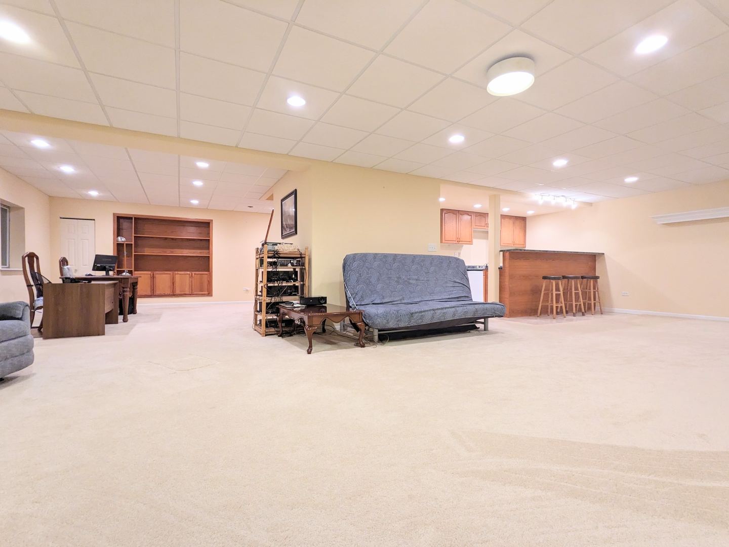 24632 Apollo Drive Plainfield, IL 60585 - Photo 18 of 22 a large room with furniture and a flat screen tv