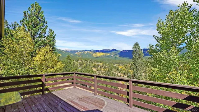 a view of a balcony with wooden floor and fence