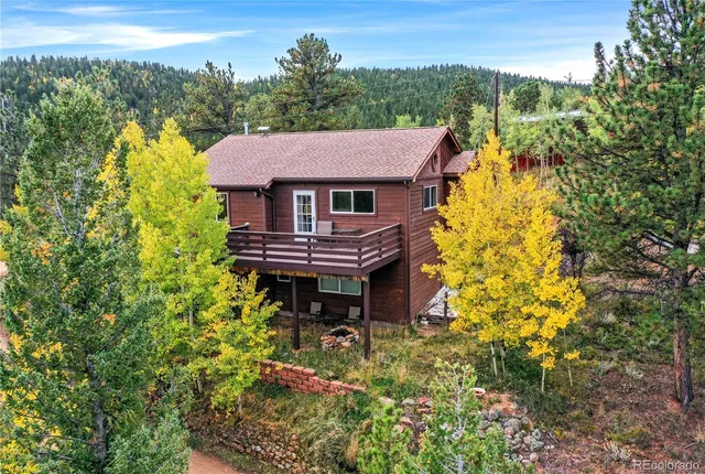 a view of a house with a yard and sitting area