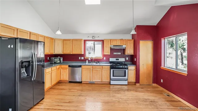 a kitchen with stainless steel appliances granite countertop a refrigerator stove and oven