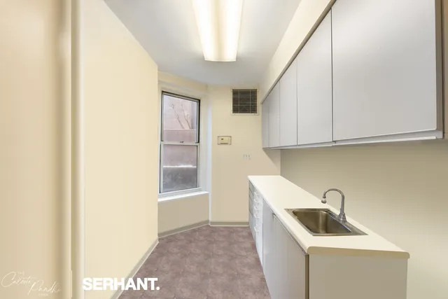 a view of kitchen with stainless steel appliances sink stove and refrigerator