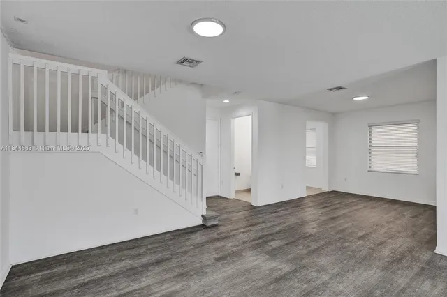 a view of kitchen with kitchen island microwave and stove