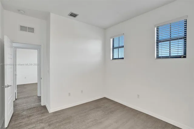 a bathroom with a double vanity sink a tub and a mirror