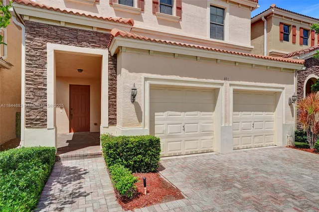 a view of an empty room with wooden floor and entryway