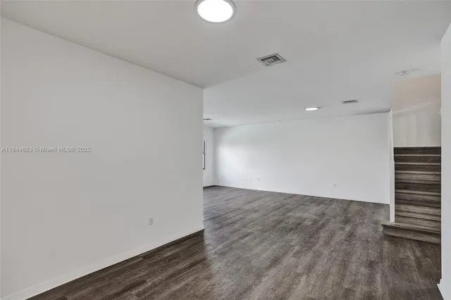 a view of an empty room with stairs