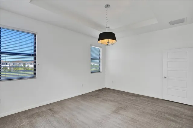 an aerial view of a house with a yard and plants