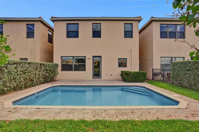 an aerial view of residential houses with outdoor space and river