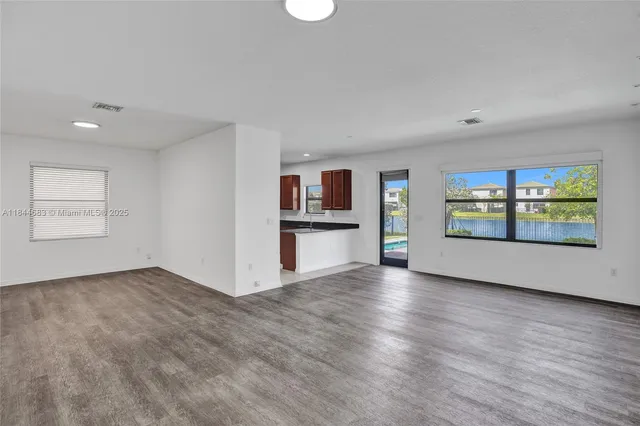 a view of an entryway with wooden floor