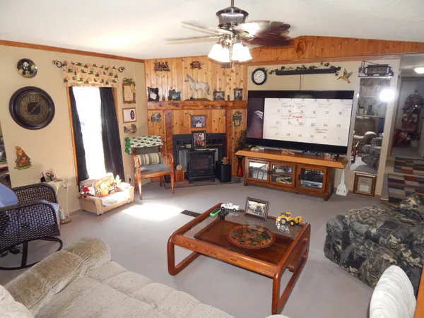 a kitchen with stainless steel appliances kitchen island granite countertop a refrigerator and a stove top oven