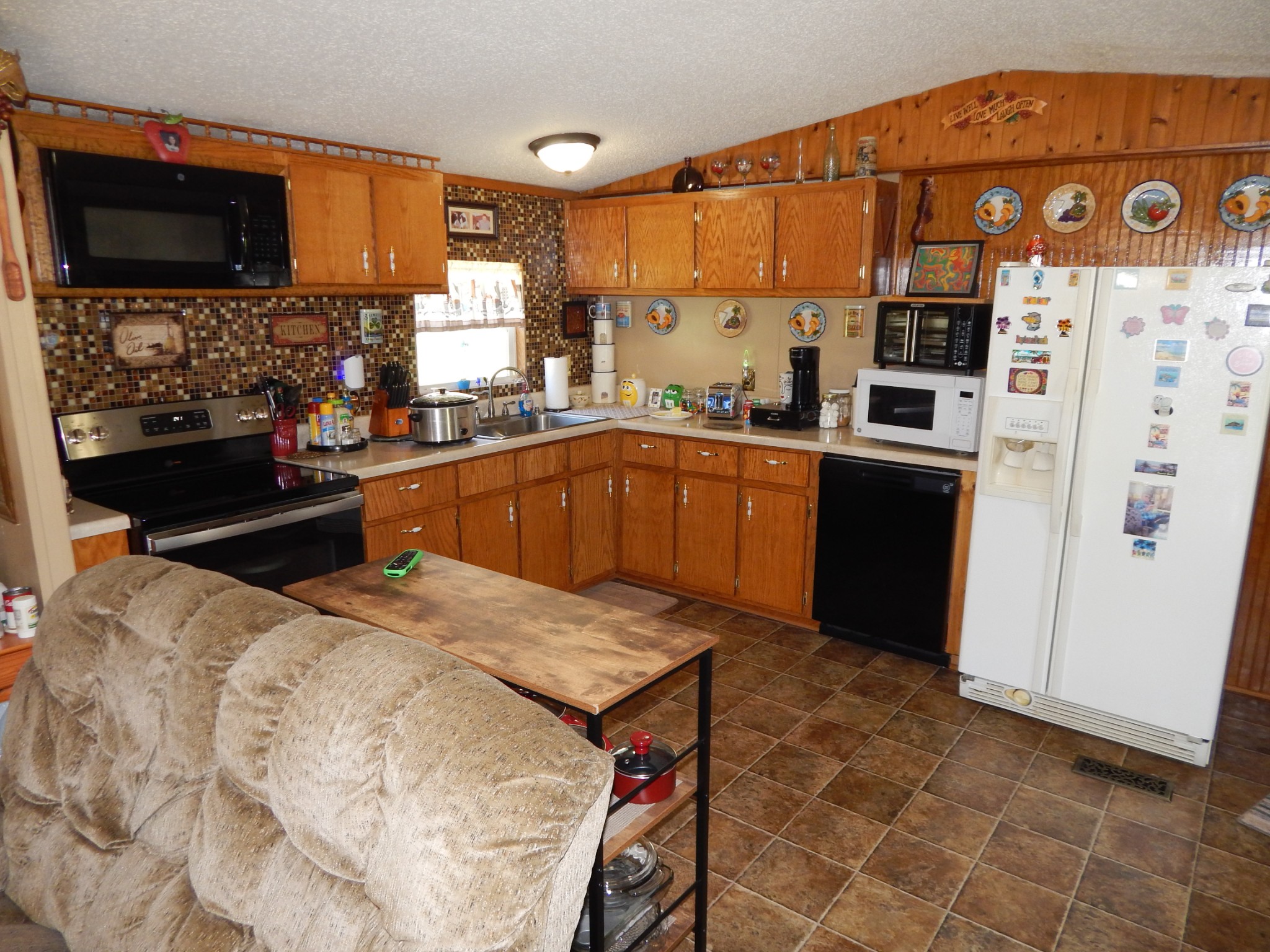 6223 Beech Creek Road Clifton, TN 38425 - Photo 14 of 68 a kitchen with stainless steel appliances kitchen island granite countertop a refrigerator and a stove top oven
