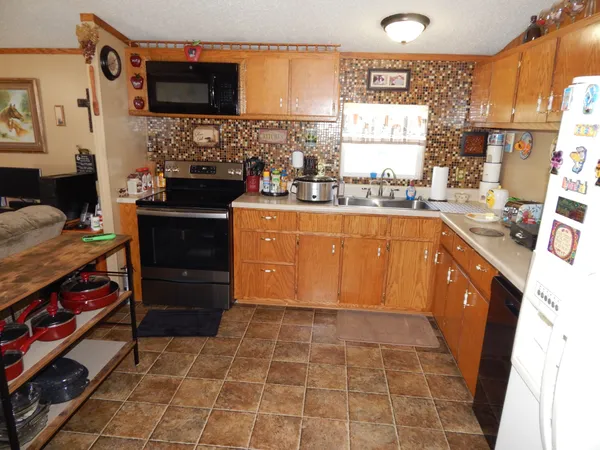 a bedroom with a bed and dresser with mirror