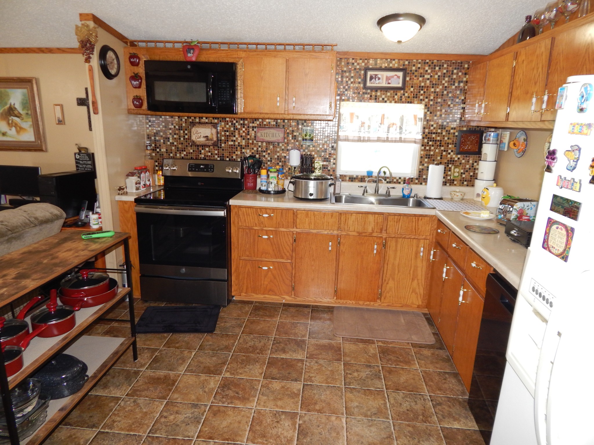 6223 Beech Creek Road Clifton, TN 38425 - Photo 16 of 68 a kitchen with stainless steel appliances a stove a sink and a microwave