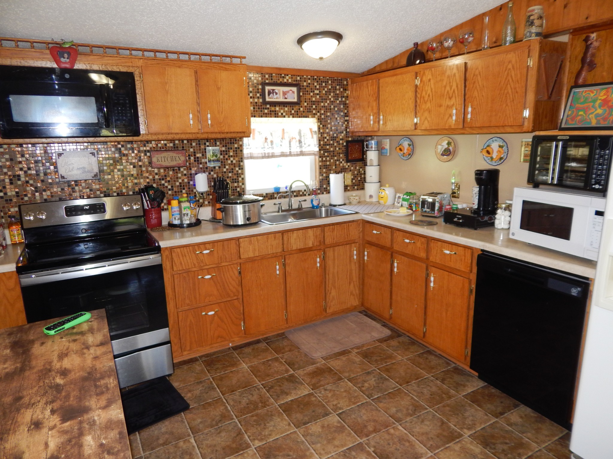 6223 Beech Creek Road Clifton, TN 38425 - Photo 17 of 68 a kitchen with stainless steel appliances granite countertop a sink stove and refrigerator