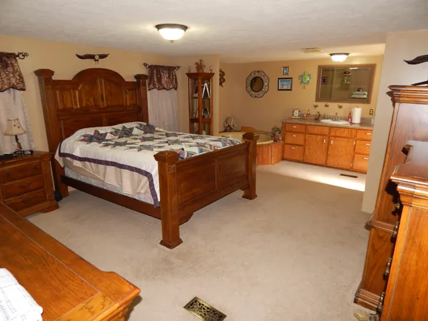 a bedroom with a bed and a dresser