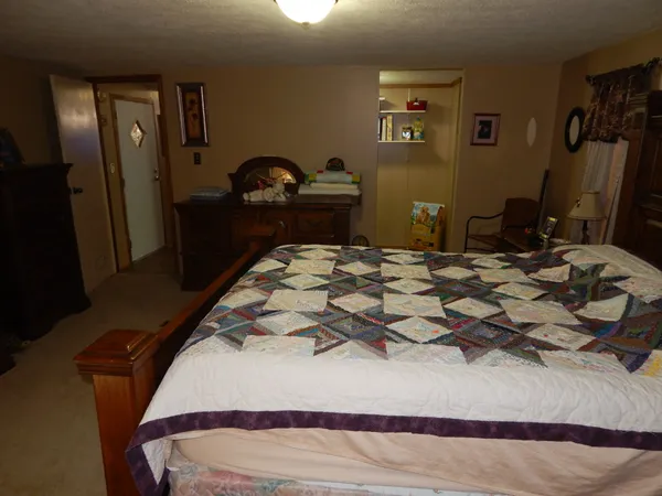 a bedroom with furniture and a window