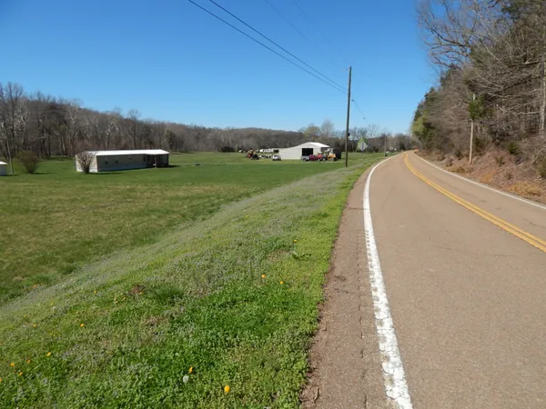 a front view of a house with a garden and yard
