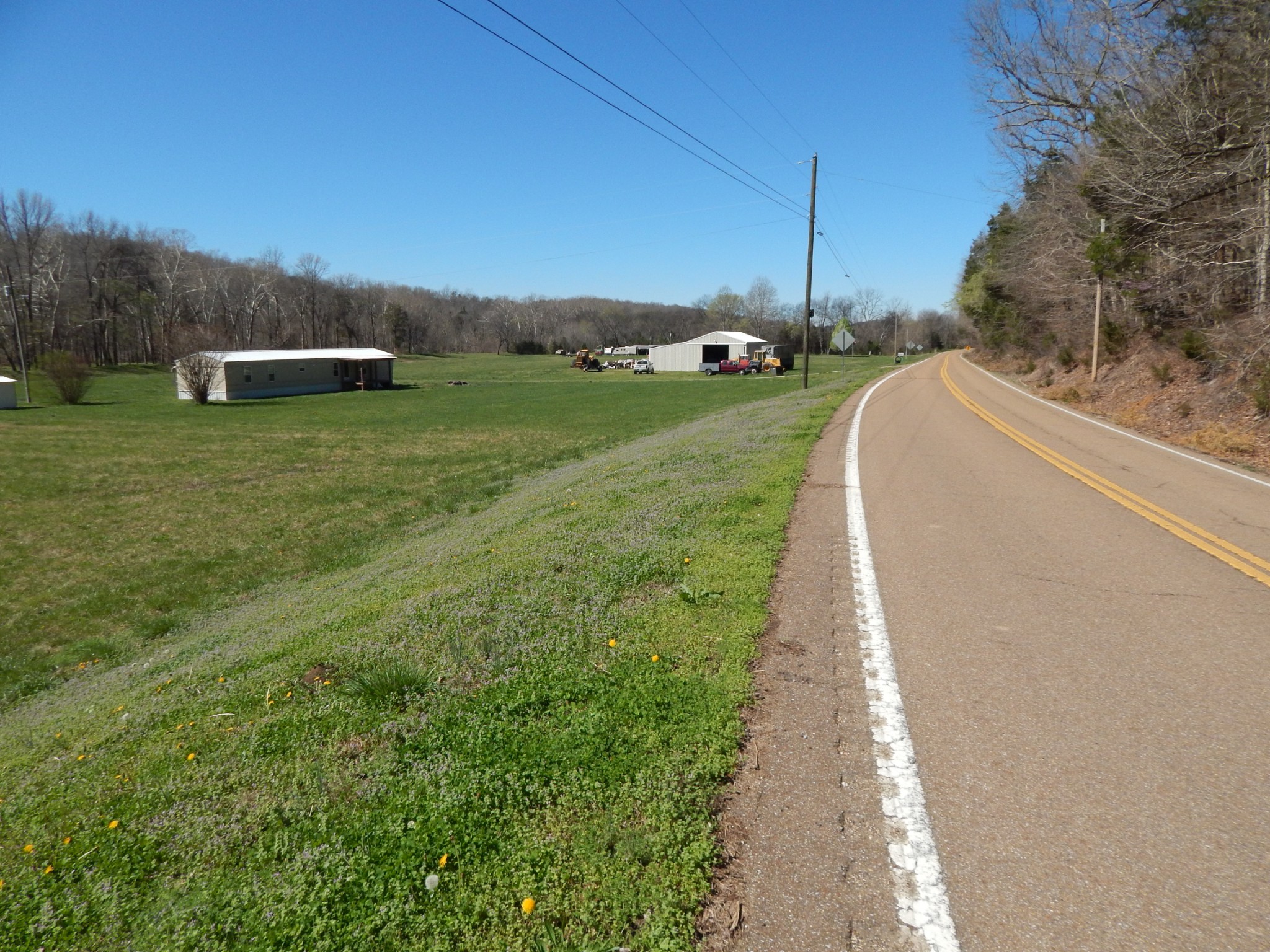 6223 Beech Creek Road Clifton, TN 38425 - Photo 4 of 68 a view of a garden with a building in the background