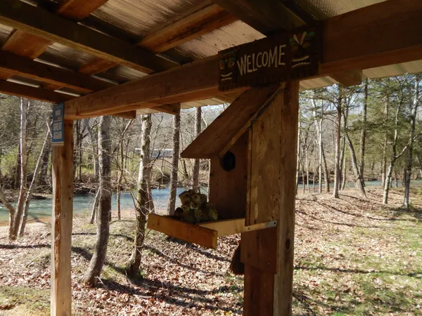 a view of a house with yard and sitting area