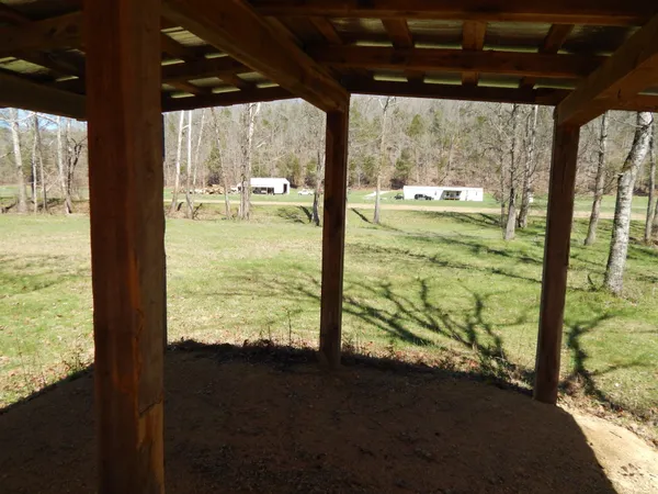 a view of outdoor space with green field and trees
