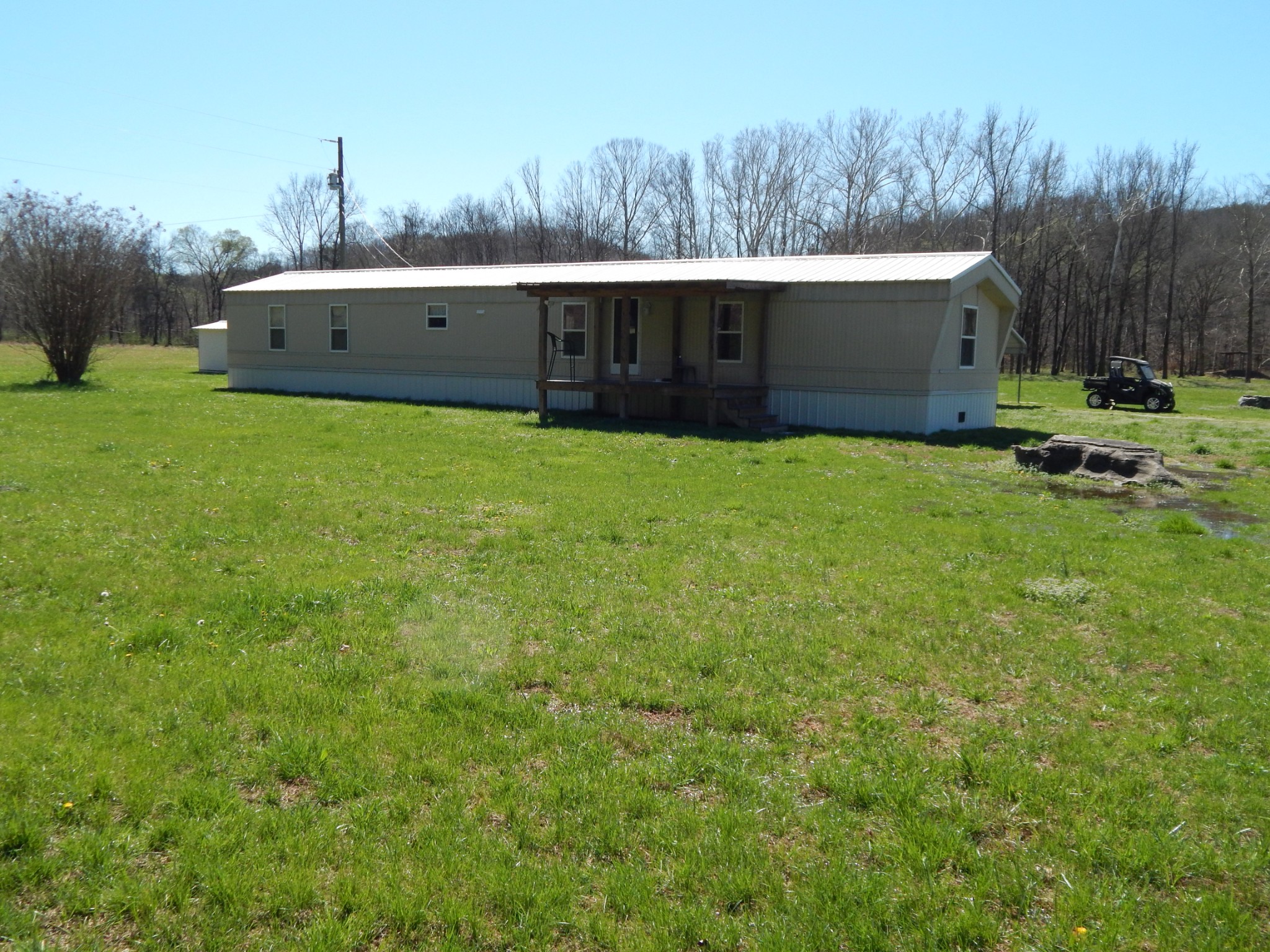 6223 Beech Creek Road Clifton, TN 38425 - Photo 6 of 68 a front view of a house with a garden and yard