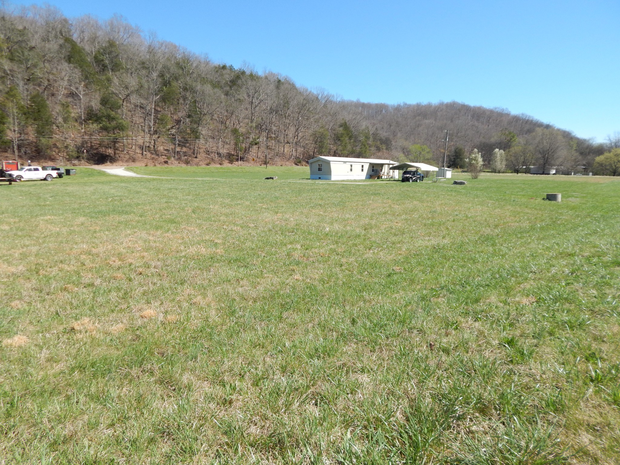 6223 Beech Creek Road Clifton, TN 38425 - Photo 62 of 68 a view of a lush green field with mountains in the background