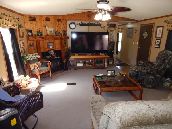 a living room with patio furniture and a chandelier