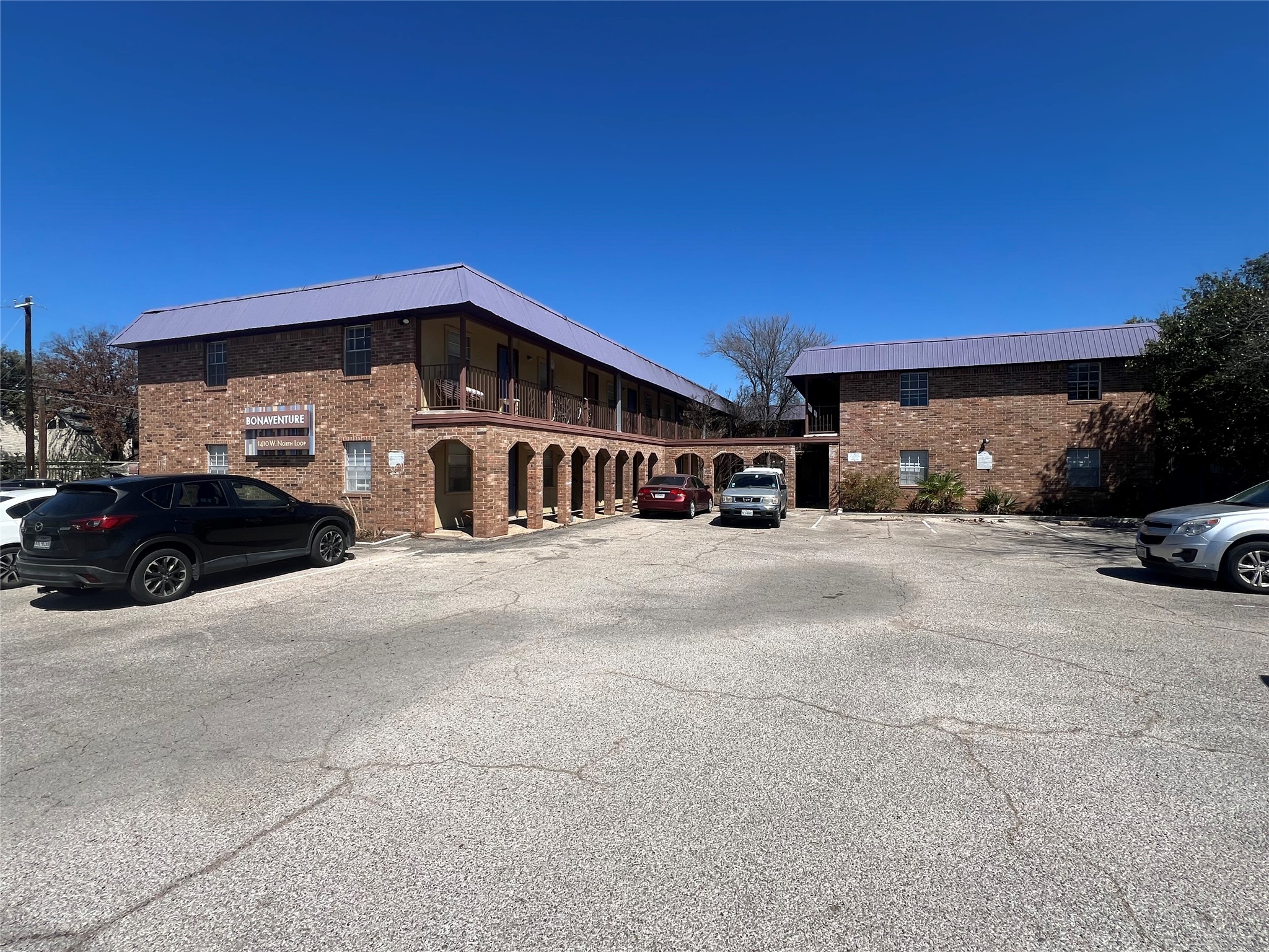 a view of building with car parked
