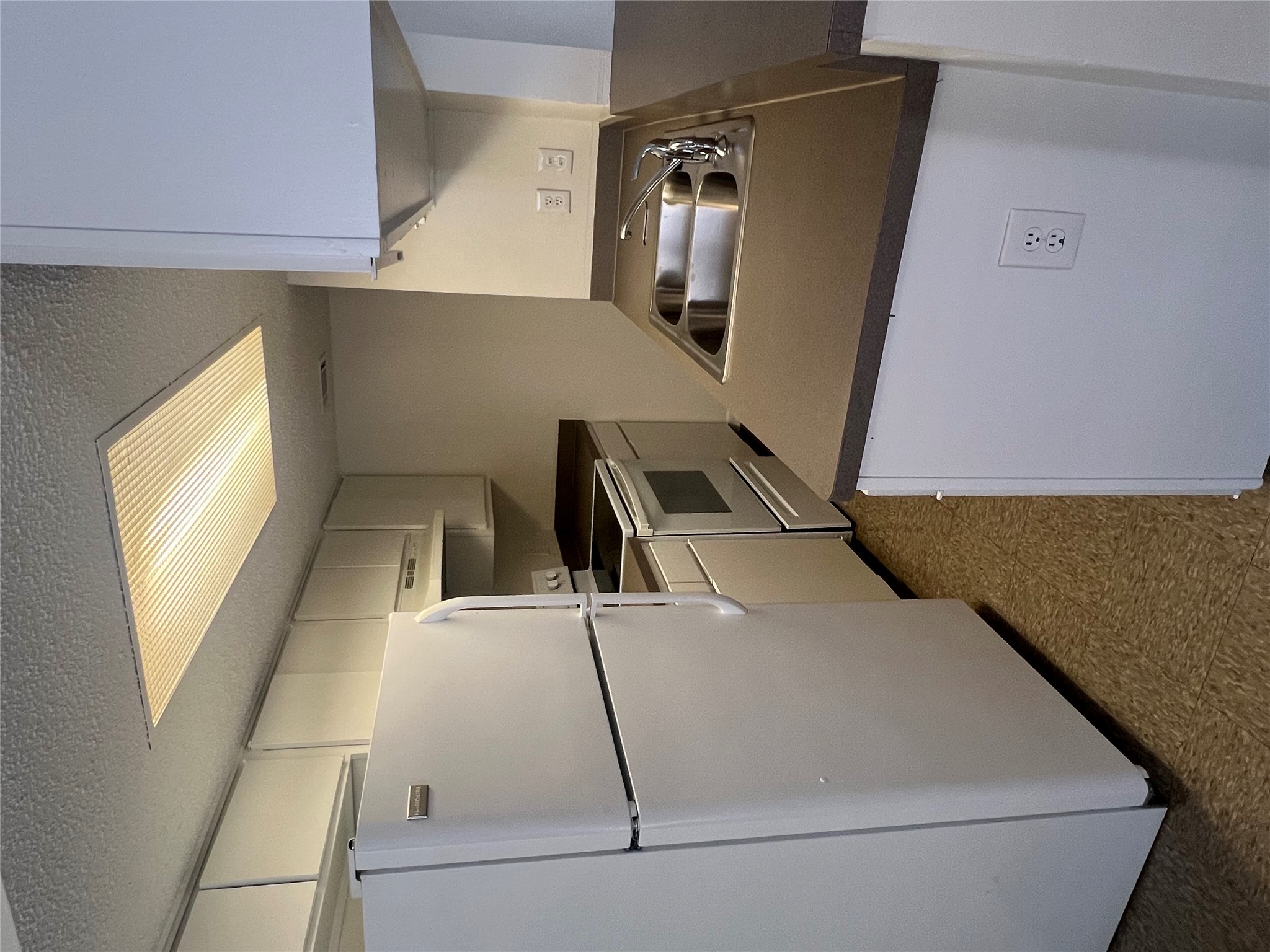 1410 West N Loop Boulevard, Unit 102 Austin, TX 78756 - Photo 11 of 24 a kitchen with a refrigerator and a stove