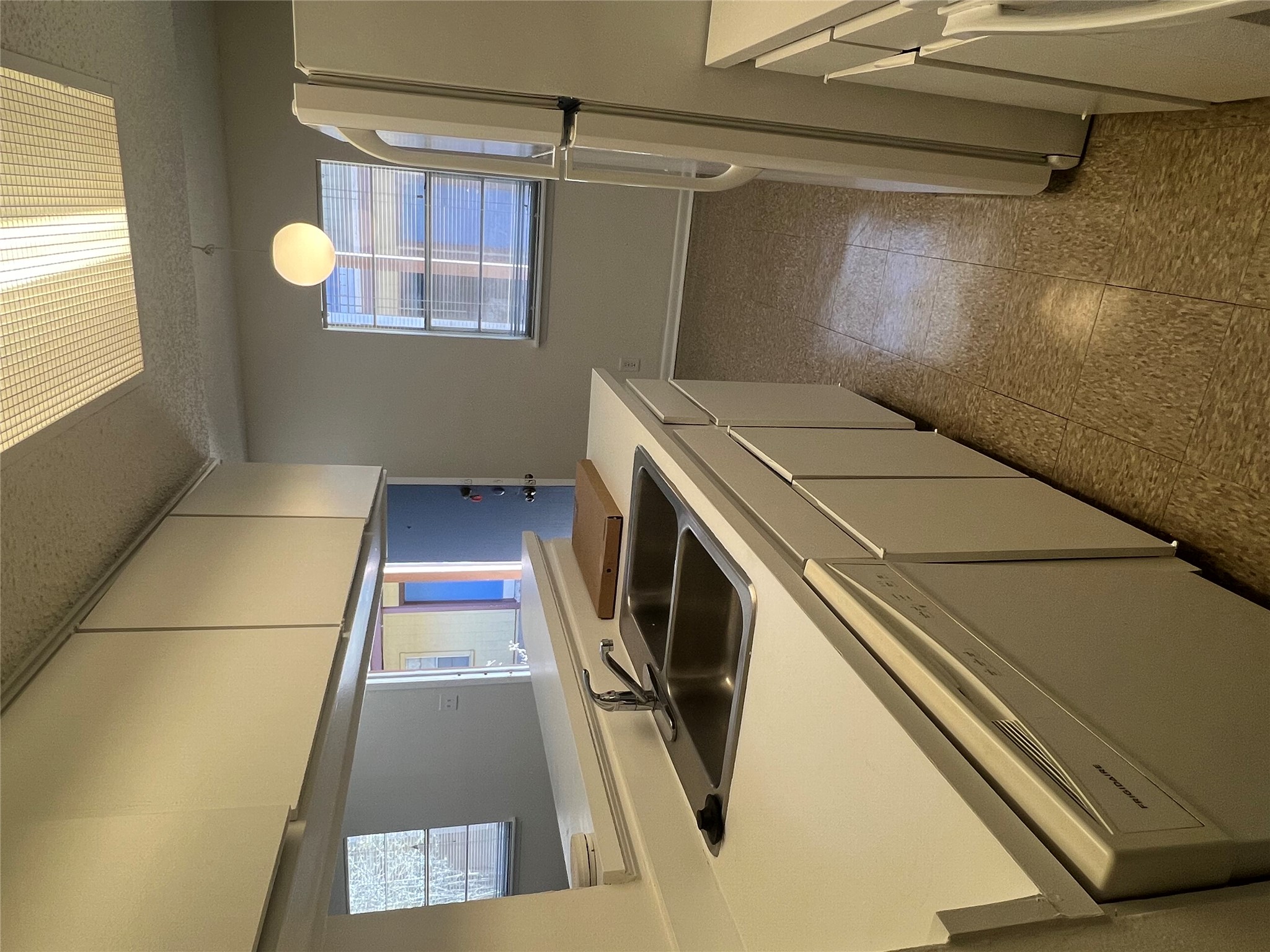 1410 West N Loop Boulevard, Unit 102 Austin, TX 78756 - Photo 12 of 24 a kitchen that has a sink and a refrigerator