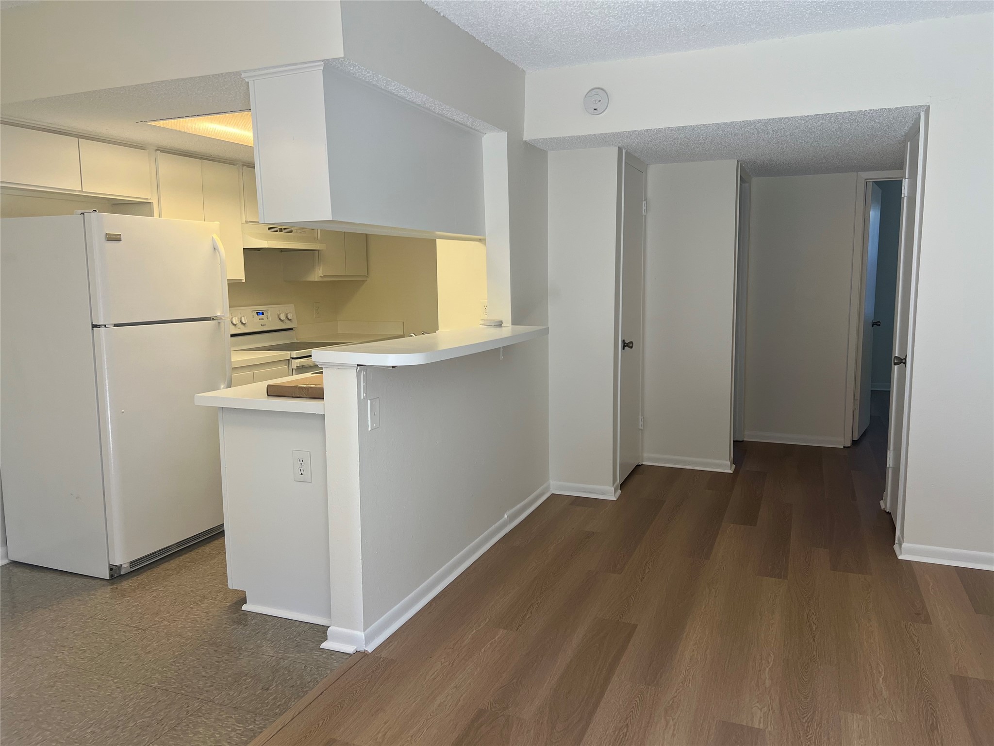 1410 West N Loop Boulevard, Unit 102 Austin, TX 78756 - Photo 13 of 24 a view of kitchen and wooden floor