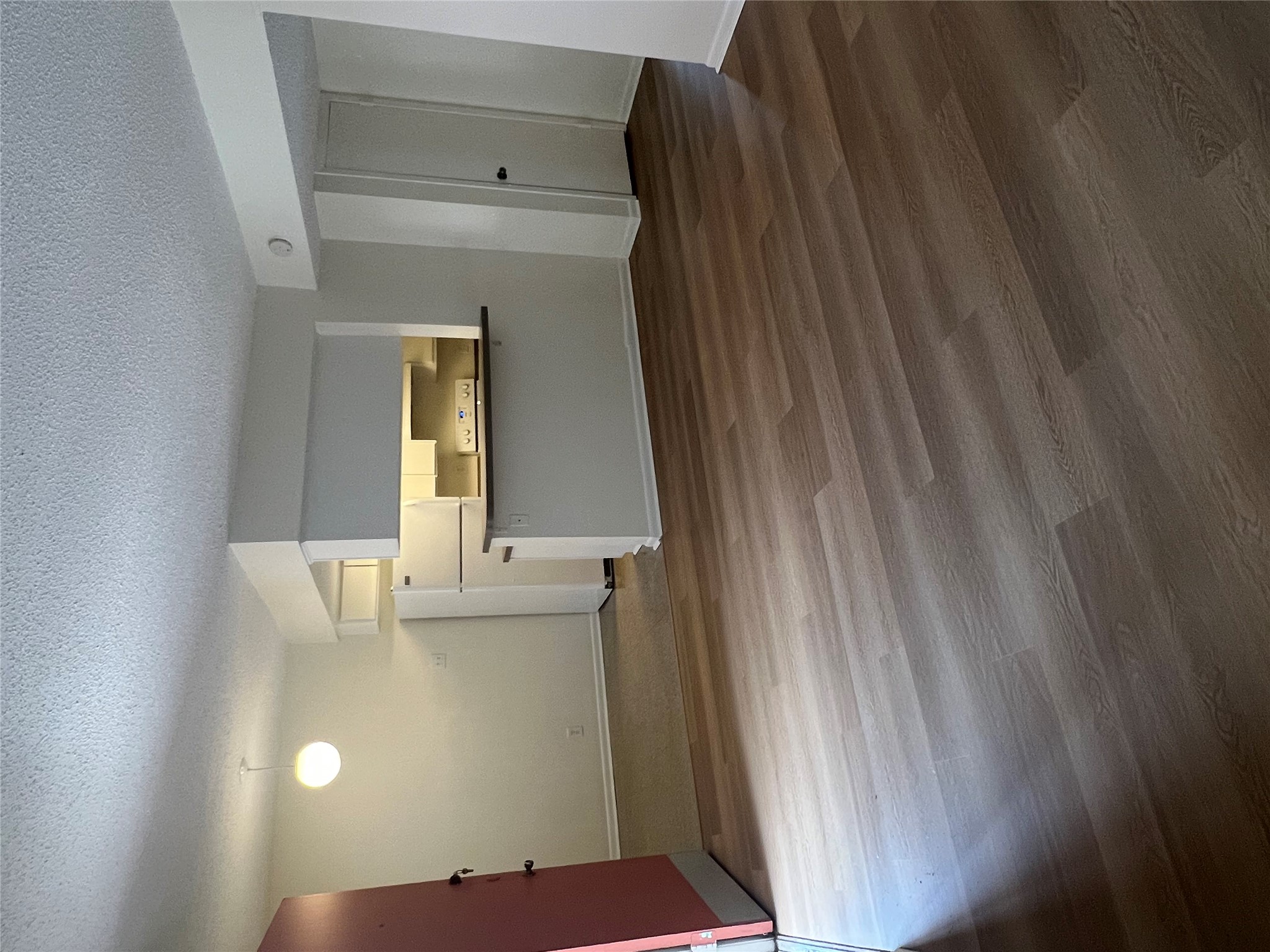 1410 West N Loop Boulevard, Unit 102 Austin, TX 78756 - Photo 16 of 24 a view of a kitchen with wooden floor and a ceiling fan