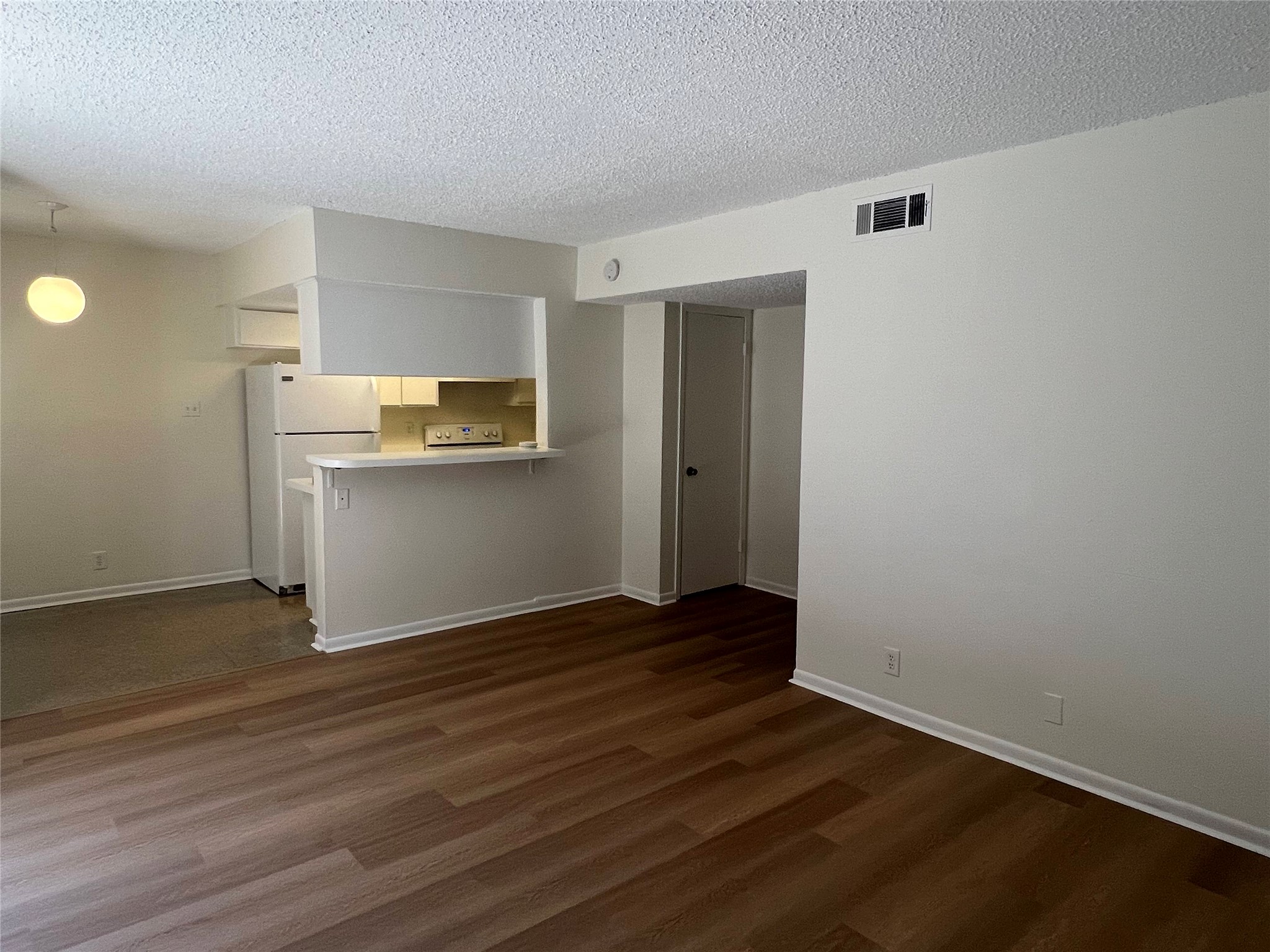 1410 West N Loop Boulevard, Unit 102 Austin, TX 78756 - Photo 17 of 24 a view of a kitchen with wooden floor and electronic appliances