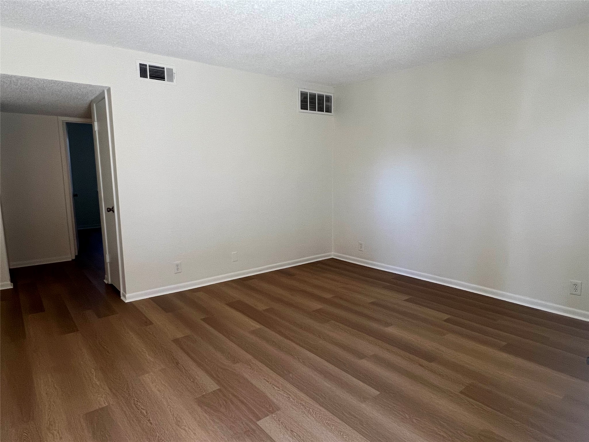 1410 West N Loop Boulevard, Unit 102 Austin, TX 78756 - Photo 18 of 24 a view of an empty room with wooden floor and a window