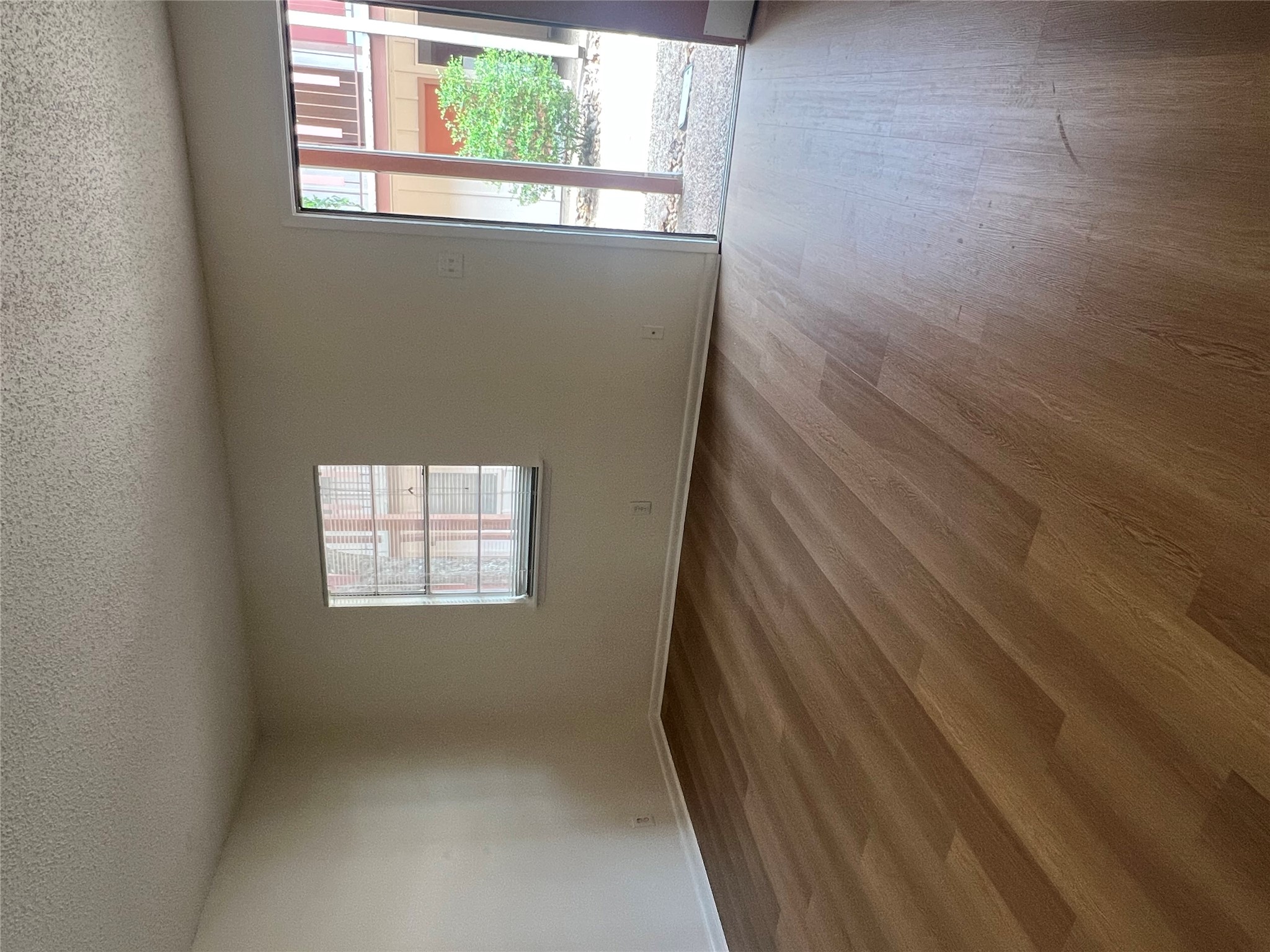 1410 West N Loop Boulevard, Unit 102 Austin, TX 78756 - Photo 20 of 24 an empty room with wooden floor and windows