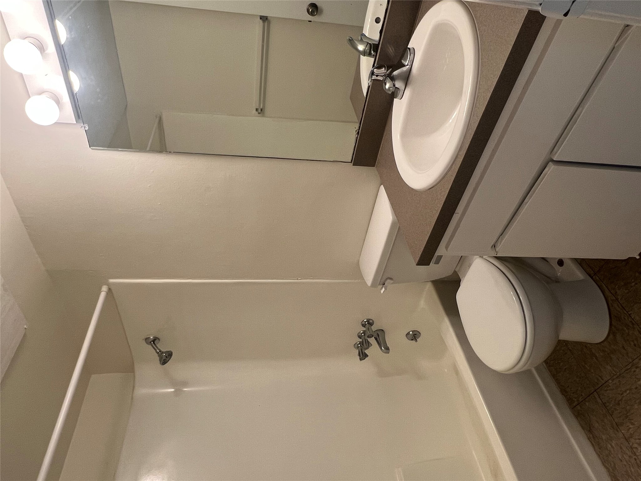 1410 West N Loop Boulevard, Unit 102 Austin, TX 78756 - Photo 22 of 24 a bathroom with a sink a toilet and shower
