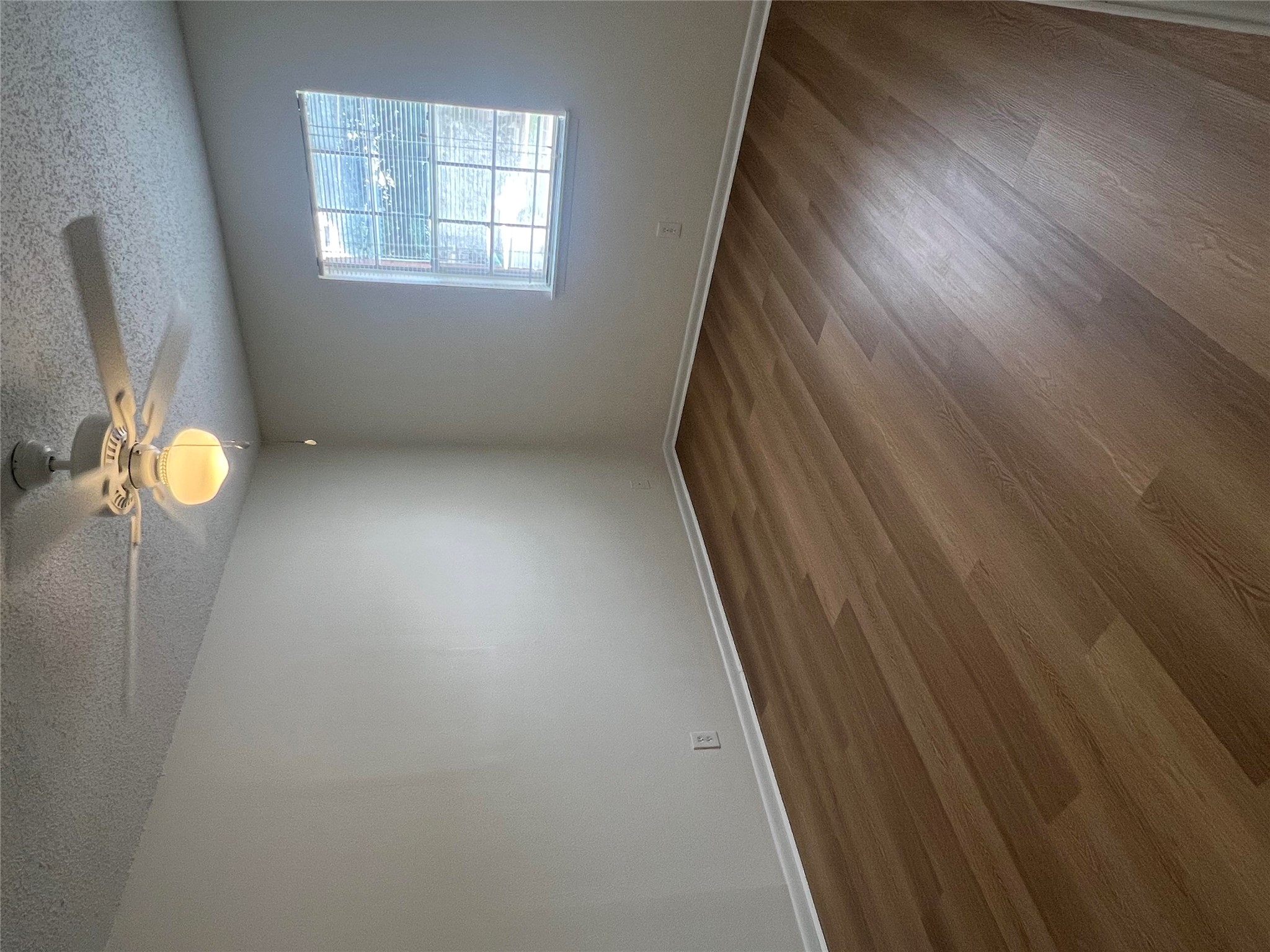1410 West N Loop Boulevard, Unit 102 Austin, TX 78756 - Photo 23 of 24 an empty room with wooden floor and windows