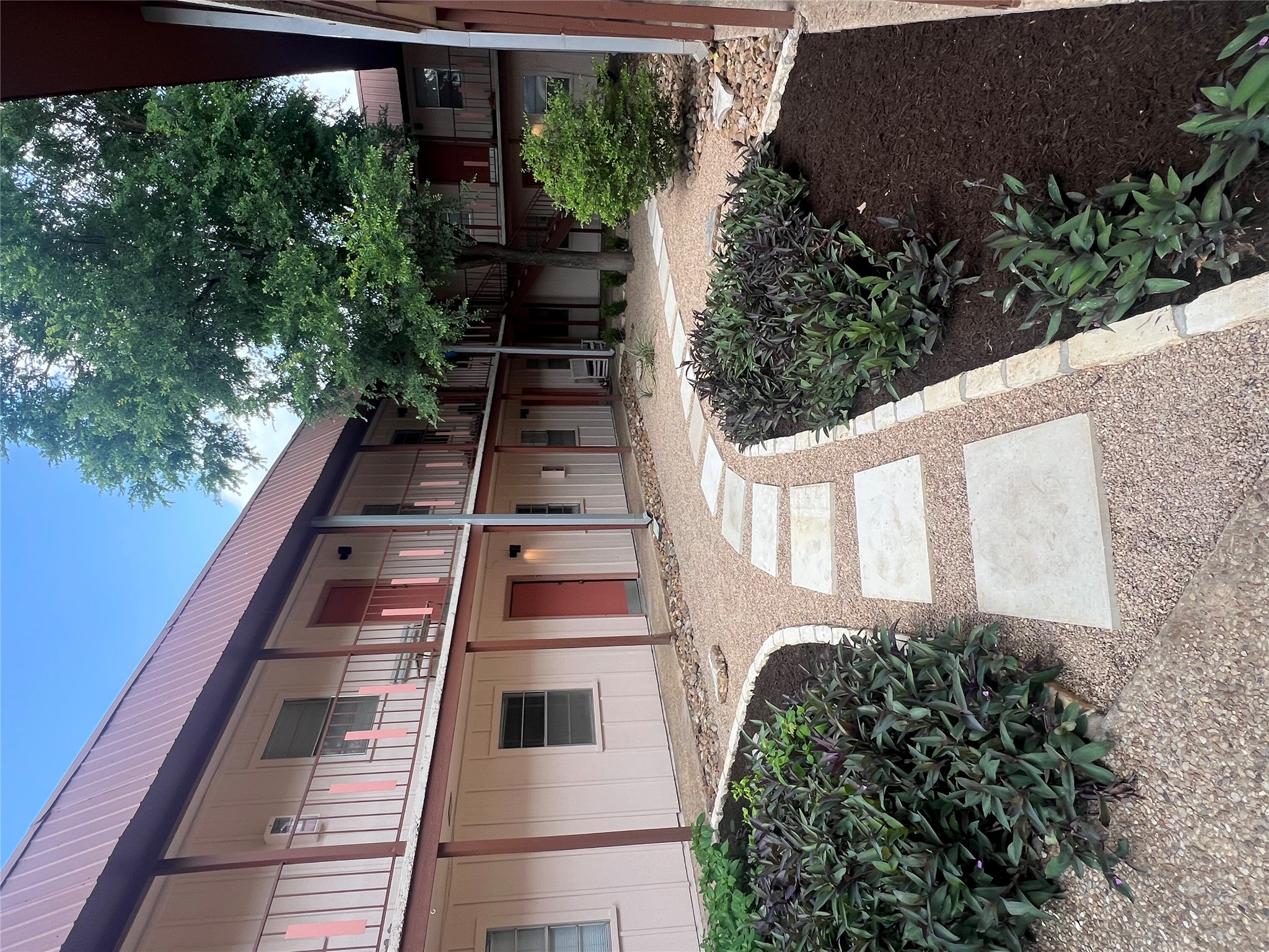 1410 West N Loop Boulevard, Unit 102 Austin, TX 78756 - Photo 7 of 24 a front view of a house with a yard