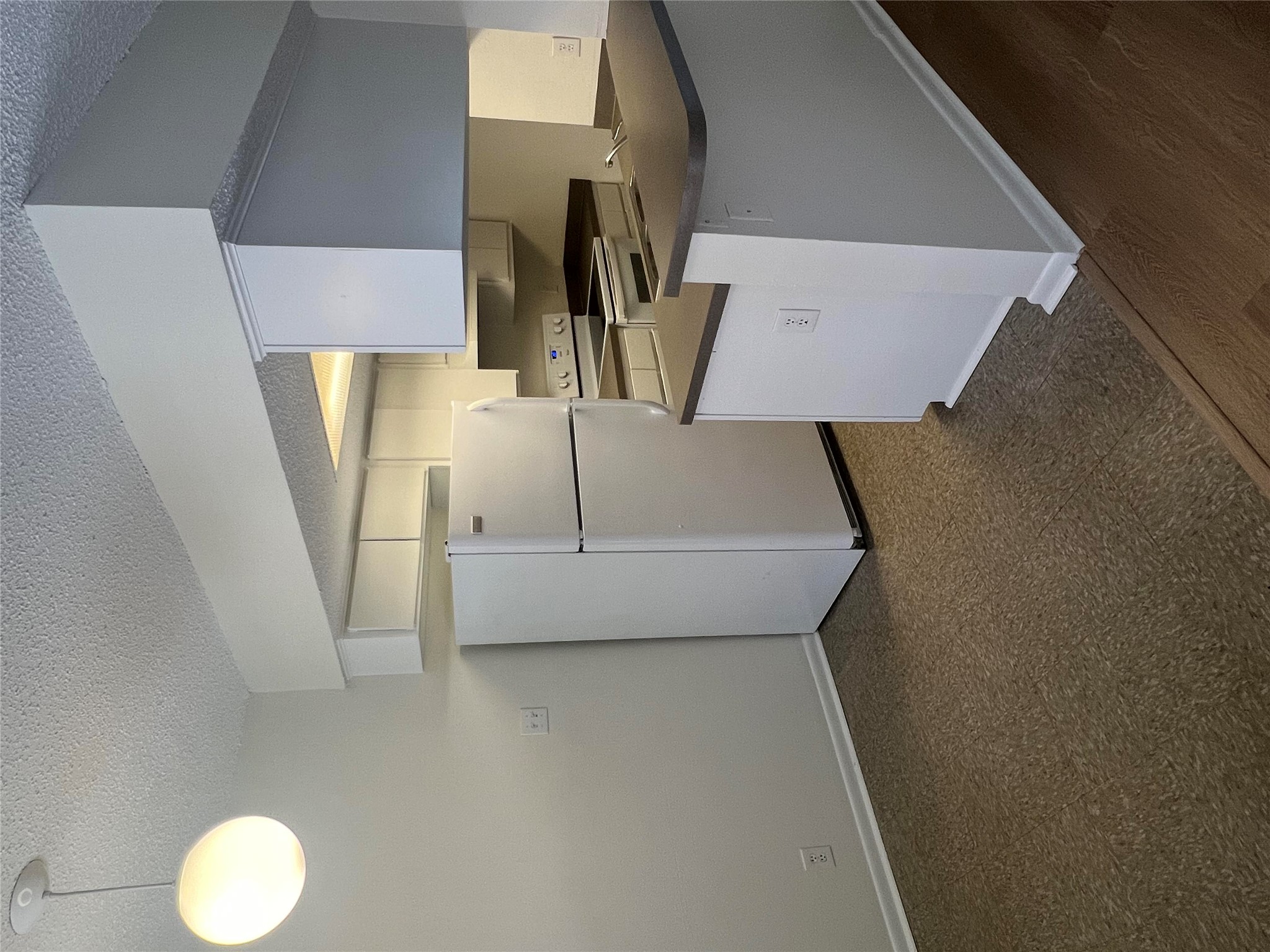 1410 West N Loop Boulevard, Unit 102 Austin, TX 78756 - Photo 10 of 24 a kitchen with cabinets and white appliances