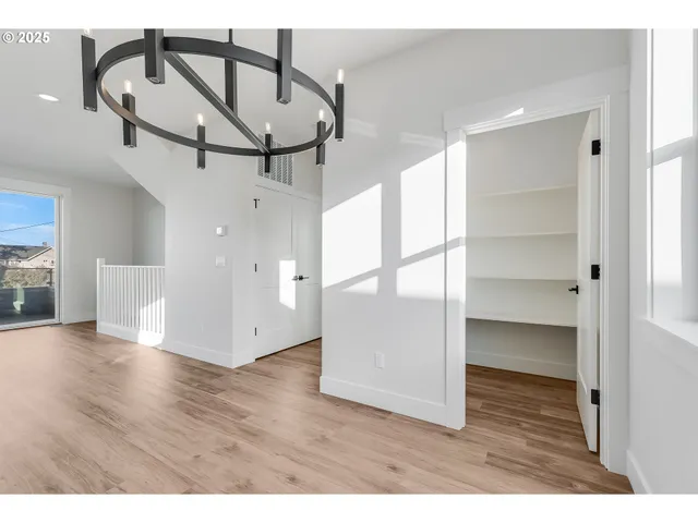 a view interior of a house with wooden floor windows and a kitchen view
